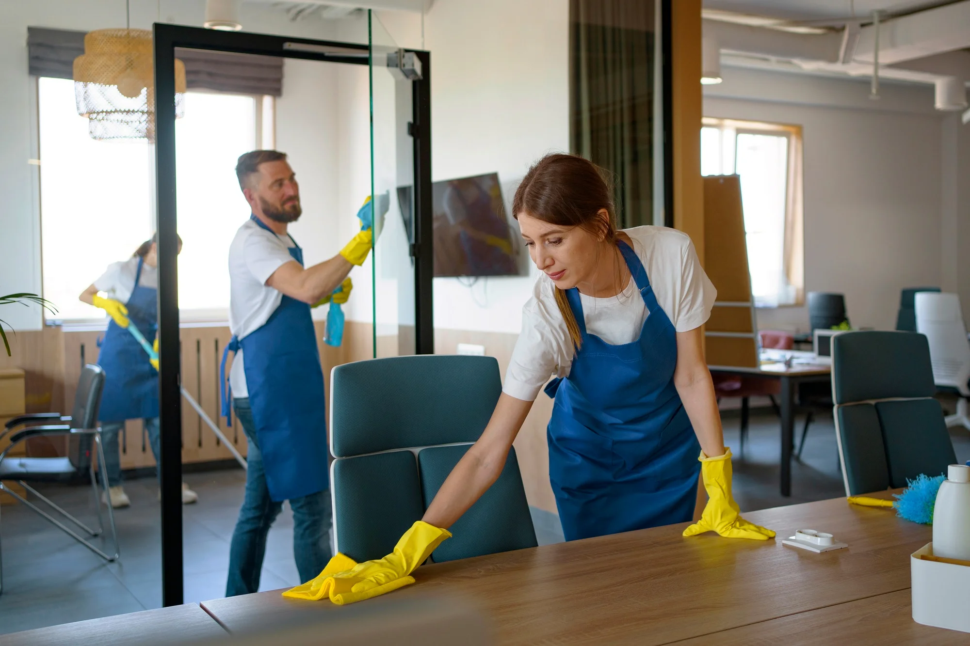 Professional cleaning service people working together in an office
