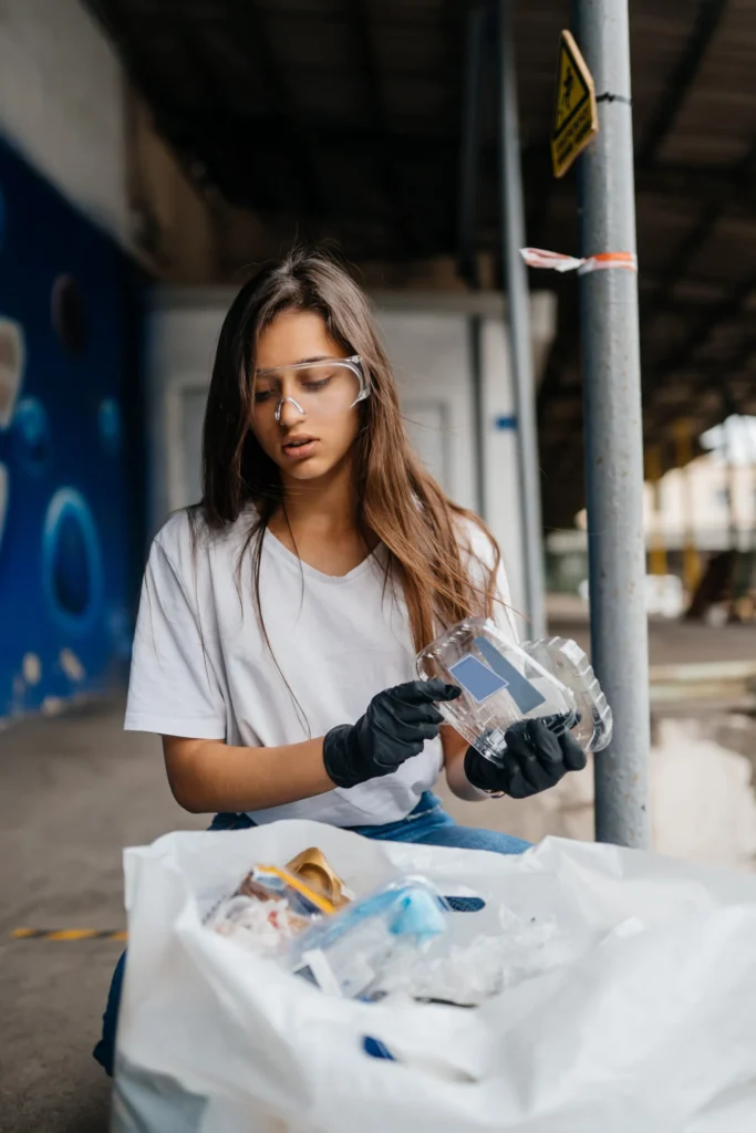 young-woman-sorting-garbage-scaled