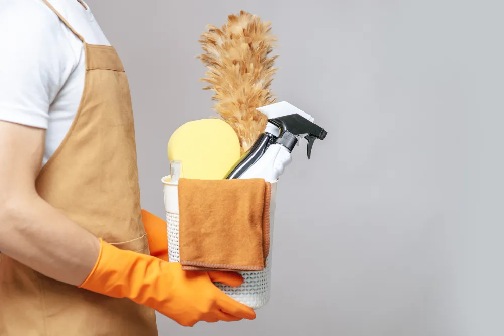 Side view, close up hand of young man in apron and rubber gloves holding a bask_converted