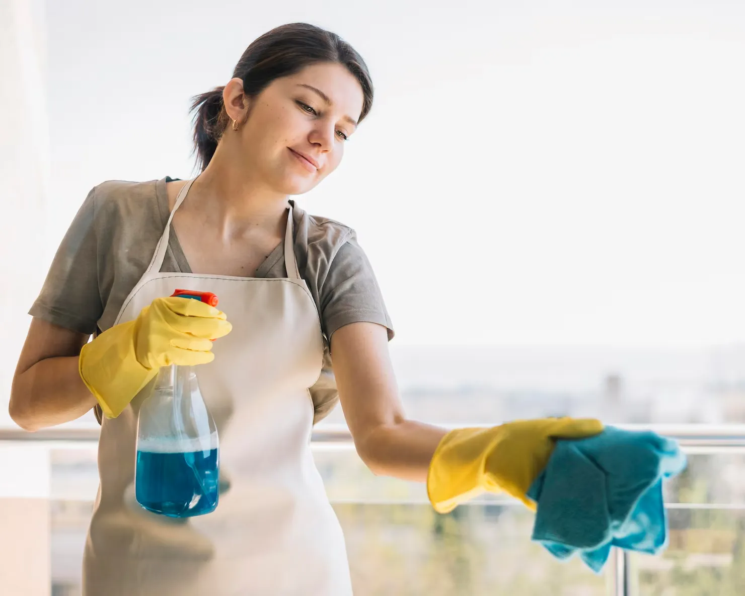 Smiley woman cleaning window_converted